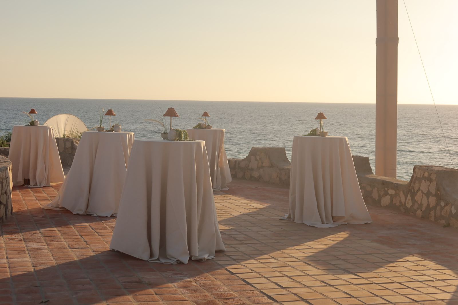 Cocktail tables on the terracotta terrace at sunset